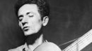 Woody-guthrie-playing-guitar