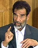 Saddam in the Dock: Counsel Denied, Hearing Censored, Calls Bush "Criminal"