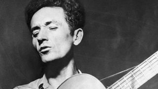 Woody guthrie playing guitar