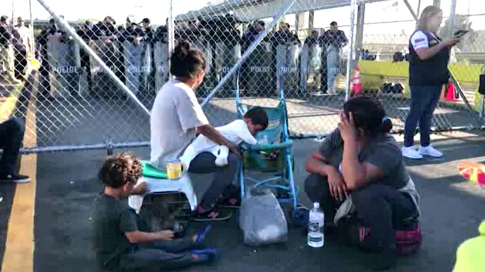H10 asylum protest seekers protest remain in mexico brownsville border bridge matamoros mexico